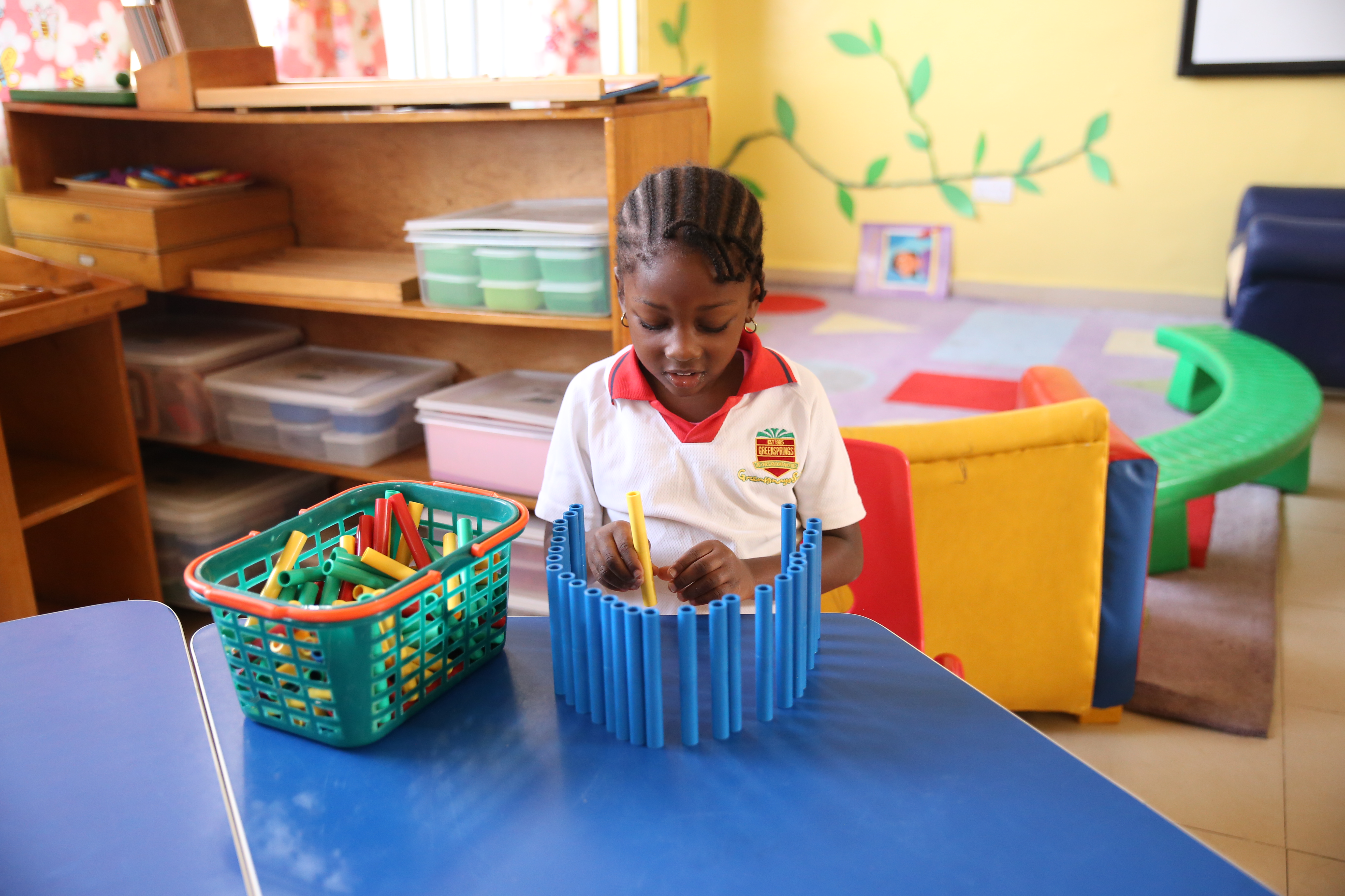 Female student at Greensprings school putting together an item in the classroom