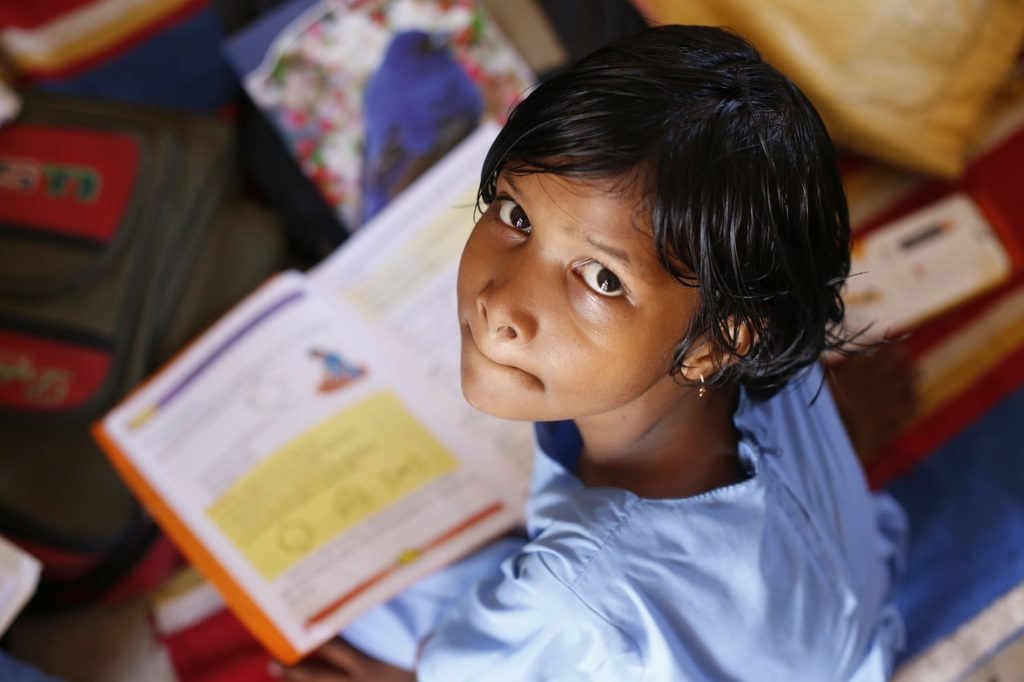 Child struggling with reading in Nigeria. 